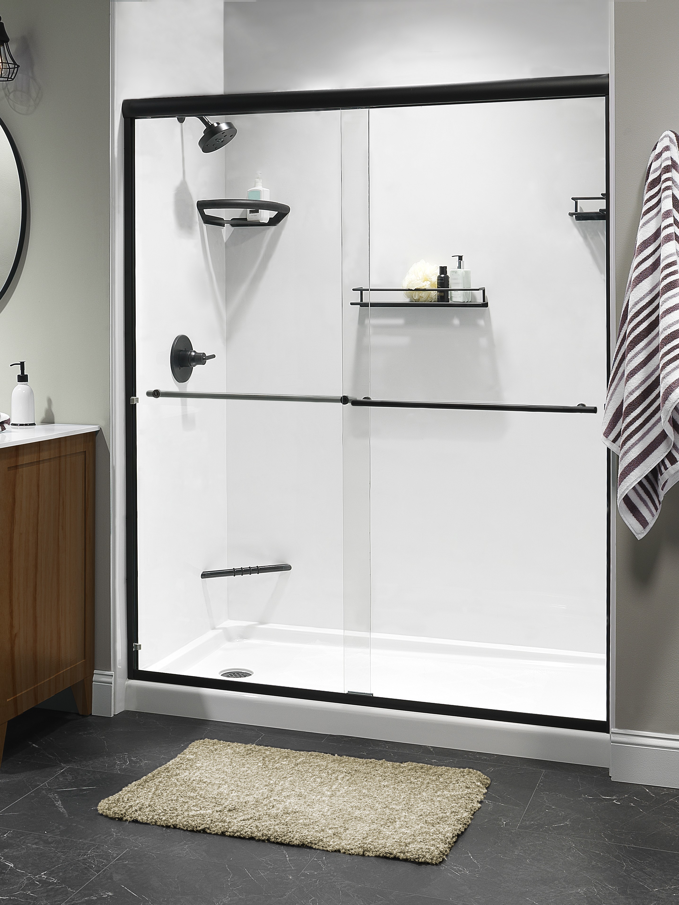Clean white shower with black frame sliding doors