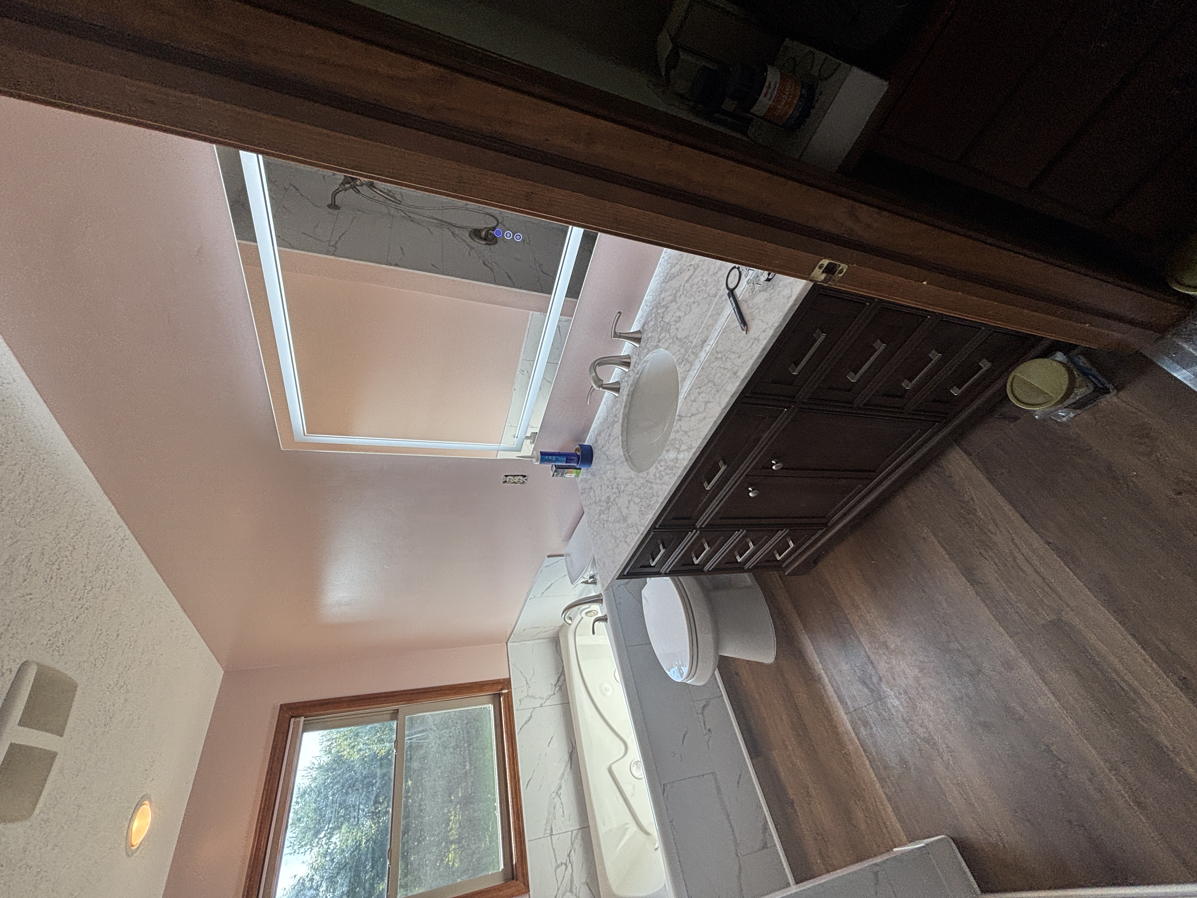 Marble vanity with tub area and luxury finishes
